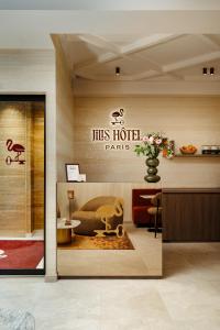 a lobby of a hotel with a sign for his hotelarks at Jills Hôtel in Paris