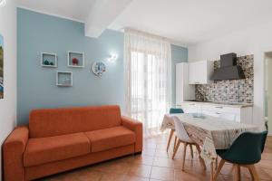 a living room with a couch and a table at Kairos San Vito Lo Capo in San Vito lo Capo