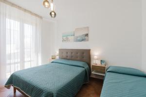 a bedroom with two beds and a window at Kairos San Vito Lo Capo in San Vito lo Capo +18 photos
