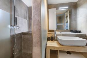 a bathroom with a sink and a shower at Appartamenti Petite Cerise in Pila +50 photos