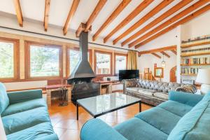 a living room with blue couches and a fireplace at ses llebres in Bunyola