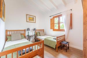 a bedroom with two beds and a window at ses llebres in Bunyola +21 photos
