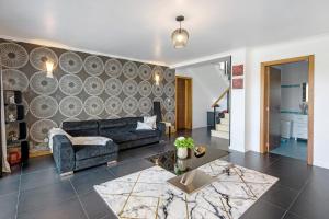 a living room with a couch and a table at Casa da Orquidea in Ribeira Grande