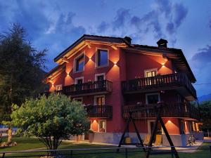 a large red building with balconies on top of it at Torre St Orso 4061 Maison Gerard in Cogne