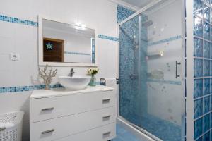 a bathroom with a sink and a shower at Casa da Orquidea in Ribeira Grande +35 photos
