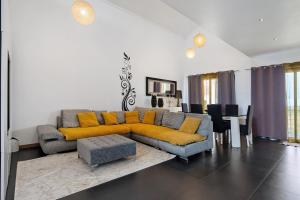 a living room with a couch and a table at Casa da Orquidea in Ribeira Grande