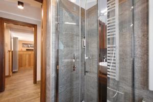 a bathroom with a shower with a glass door at Torre St Orso 4061 Maison Gerard in Cogne +30 photos