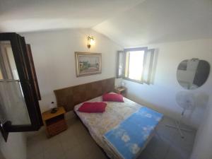 a small bedroom with a bed and a mirror at Casina Torre in Torre Dei Corsari