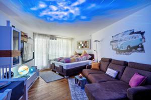 a living room with a couch and a tv at Zentrale Ferienwohnung mit Balkon in Bad Liebenzell