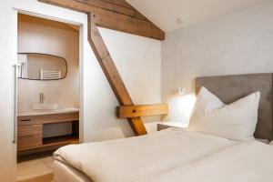 a bedroom with a bed and a sink and a mirror at Appartements N°37 in Hüttschlag