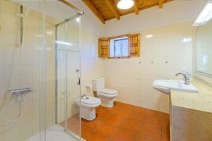 a bathroom with a toilet and a sink and a shower at Monte do Cerro Verde in Santiago do Cacém +19 photos