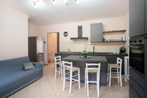 a kitchen with a table and chairs in a room at Il Frutteto 49 in Ortovero