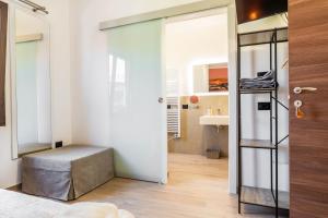 a room with a bench and a room with a mirror at Su Carinniu in Villacidro +42 photos