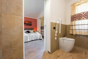 two images of a bedroom with a bed and a bathroom at Su Carinniu in Villacidro