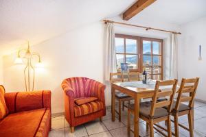 a living room with a table and a chair at Beim Blitz ehemals Haus Maier in Schwangau