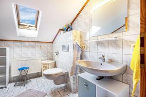 a bathroom with a sink and a toilet and a mirror at Beim Blitz ehemals Haus Maier in Schwangau +82 photos