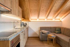 a living room with a couch and a table at Feldererhof GsiesApt Dolomitenblick in Valle Di Casies