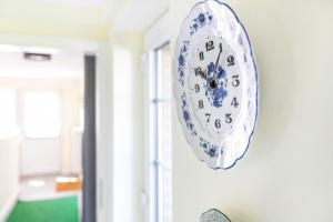 a blue and white clock hanging on a wall at Ferienhaus Erlengrund B in Schafstedt +13 photos