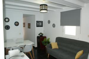 a living room with a couch and a table at O Bolaño Apto 3 in Villarino de Conso