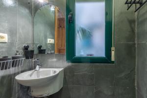 a bathroom with a sink and a mirror at Judería Apartamento in Segovia +16 photos