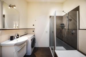 a white bathroom with a sink and a shower at Apartement Huck in Cornedo all'Isarco +35 photos