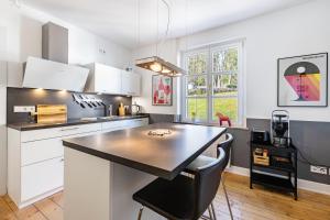 a kitchen with white cabinets and a black counter top at Attendorner Burgblick in Attendorn