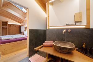 a bathroom with a bowl sink on a wooden counter at Oberplatzer in Lagundo +89 photos