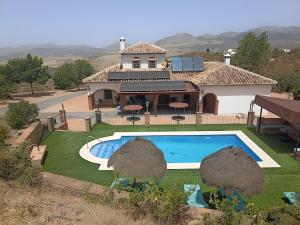 an aerial view of a house with a swimming pool at Mansión Piedras Blancas in Colmenar