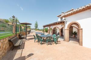 a patio with a table and chairs on it at Mansión Piedras Blancas in Colmenar