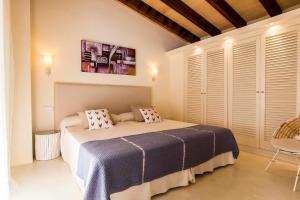 a bedroom with a bed with pillows on it at Can Bossa in Capdepera +19 photos
