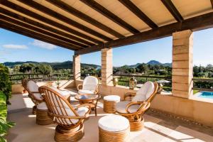 a patio with chairs and a table and a view at Can Bossa in Capdepera