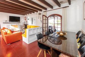 a dining room with a table and a couch at Cavall Menor in Cala Morell