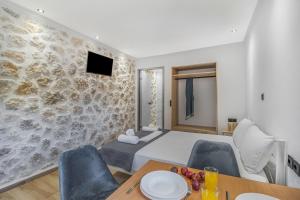 a bedroom with a bed and a table and chairs at Groundfloor Studio 1 in Tsoukalades