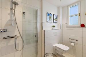 a white bathroom with a shower and a toilet at Attendorner Burgblick in Attendorn +53 photos
