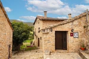 an old stone building with a door in a village at Moli d' en Pi in Morella