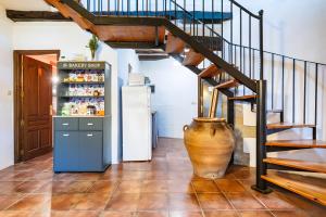 a kitchen with a staircase and a refrigerator at Moli d' en Pi in Morella