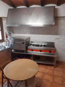 a kitchen with a stove and a table in it at Moli d' en Pi in Morella +11 photos