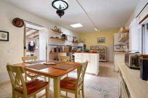 a kitchen with a wooden table and chairs in a room at Casa del Valle in Betancuría