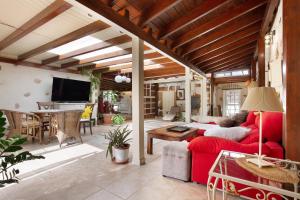 a living room with a red couch and a table at Casa del Valle in Betancuría