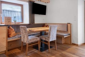 a dining room with a wooden table and chairs at Gurschlerhof in Lasa