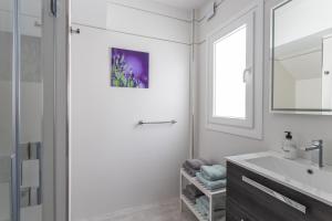 a white bathroom with a sink and a mirror at Nerja Luxury Apartment in Nerja