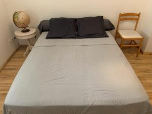 a bed in a room with a chair and a table at Maison de Violette in Serrières-de-Briord +30 photos