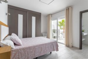 a bedroom with a bed and a balcony at Nerja Luxury Apartment in Nerja