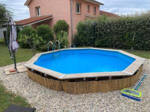 a large swimming pool in the backyard of a house at Maison de Violette in Serrières-de-Briord