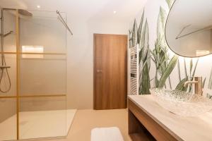a bathroom with a sink and a mirror at Appartements N°37 in Hüttschlag