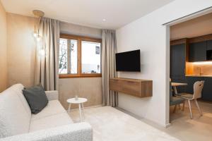 a living room with a couch and a tv at Appartements N°37 in Hüttschlag