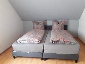 a bed with two pillows on it in a room at Ferienwohnung Huber in Oppenau