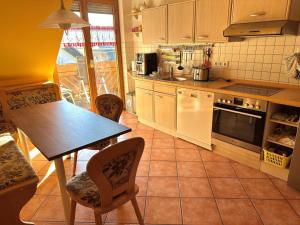 a kitchen with a table and chairs in it at Ferienwohnung Huber in Oppenau