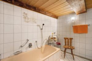 a bath tub in a bathroom with a wooden ceiling at Krährbauernhof mit Hofladen in Hornberg +77 photos