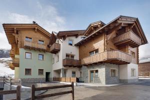 a house with wooden balconies on the side of it at Alpi Flo Chalet in Livigno